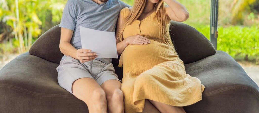 A couple reviewing documents, emphasizing the importance of pre-birth orders in California surrogacy cases to protect parental rights.